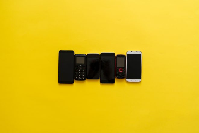 a technology evolution concept, some old vintage phone cell phones and new nodern devices