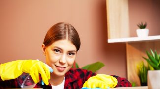 An employee of a cleaning company fulfills orders for office cleaning