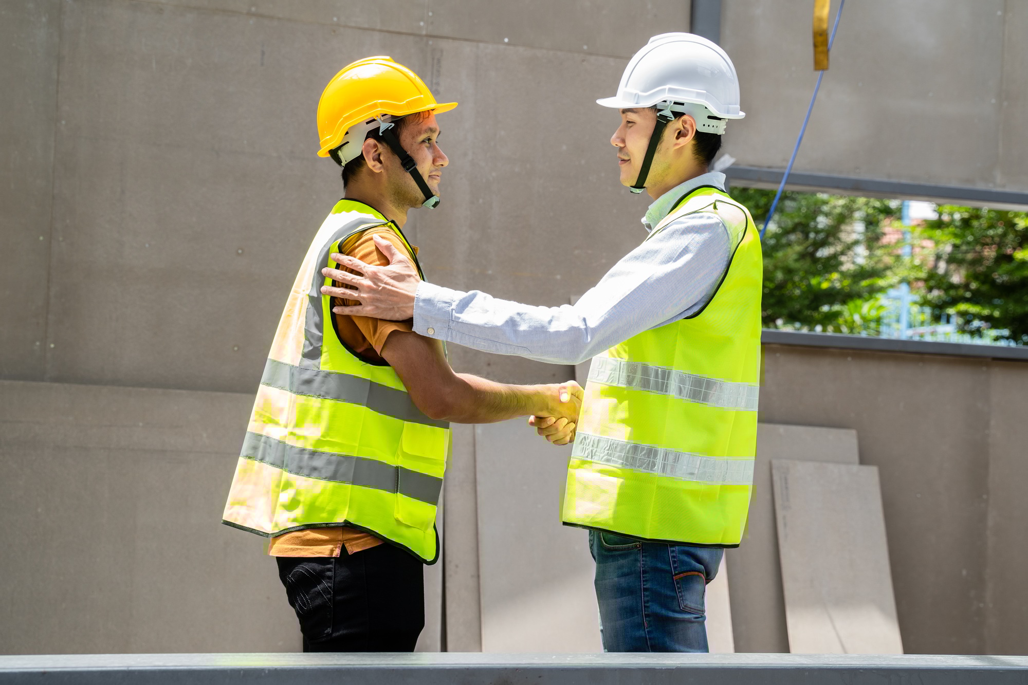 Asian structure engineer and worker making handshake on building working site for Business deal