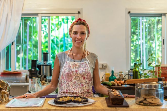 Business owner standing at the bar of her coffee and juice shop.