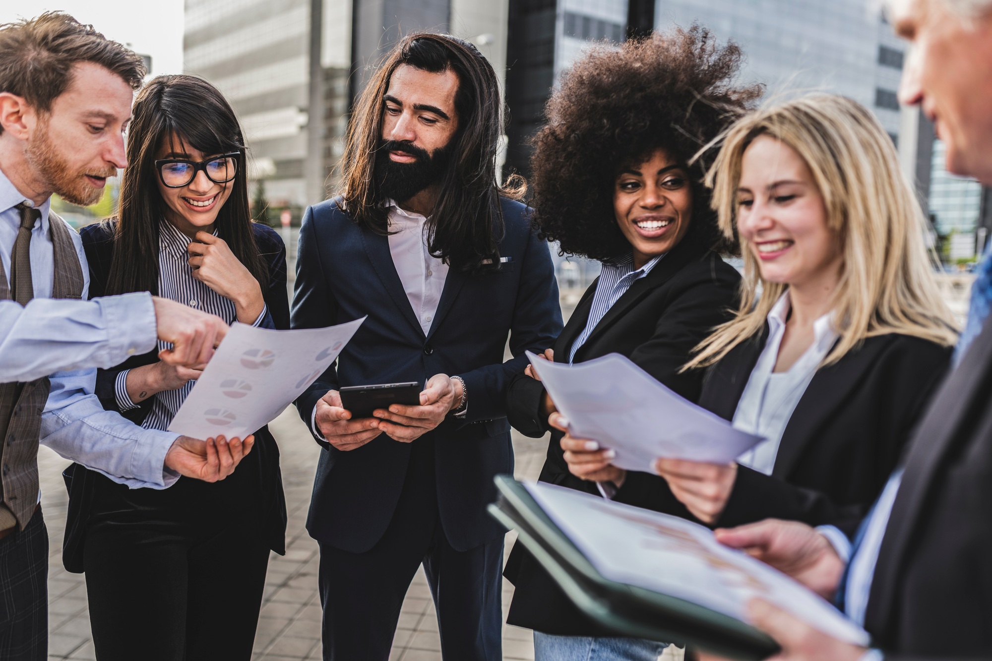 colleagues preparing presentation with infographic and graphics tablets before meeting