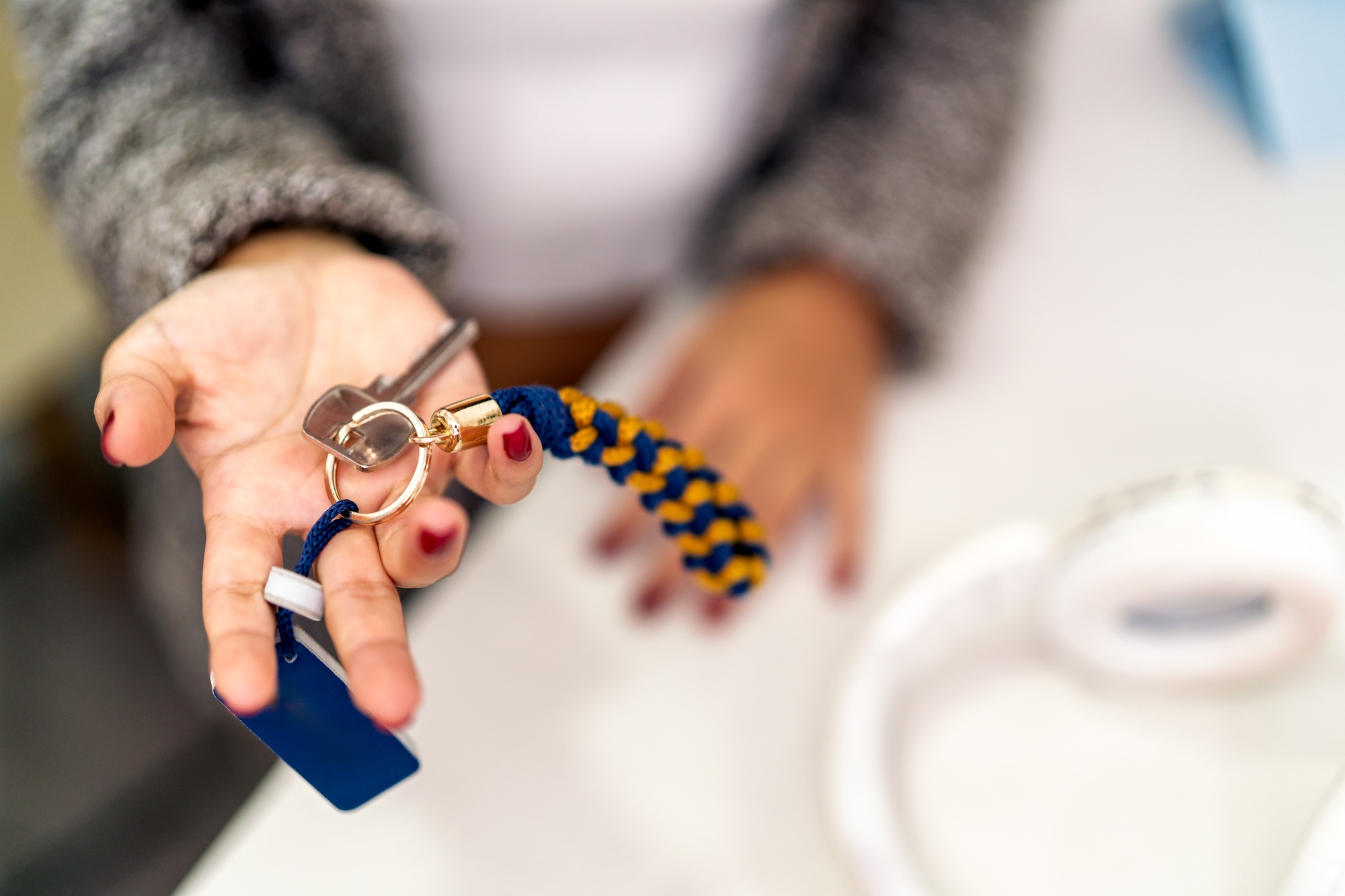 Digital nomad showing keys of airbnb apartment