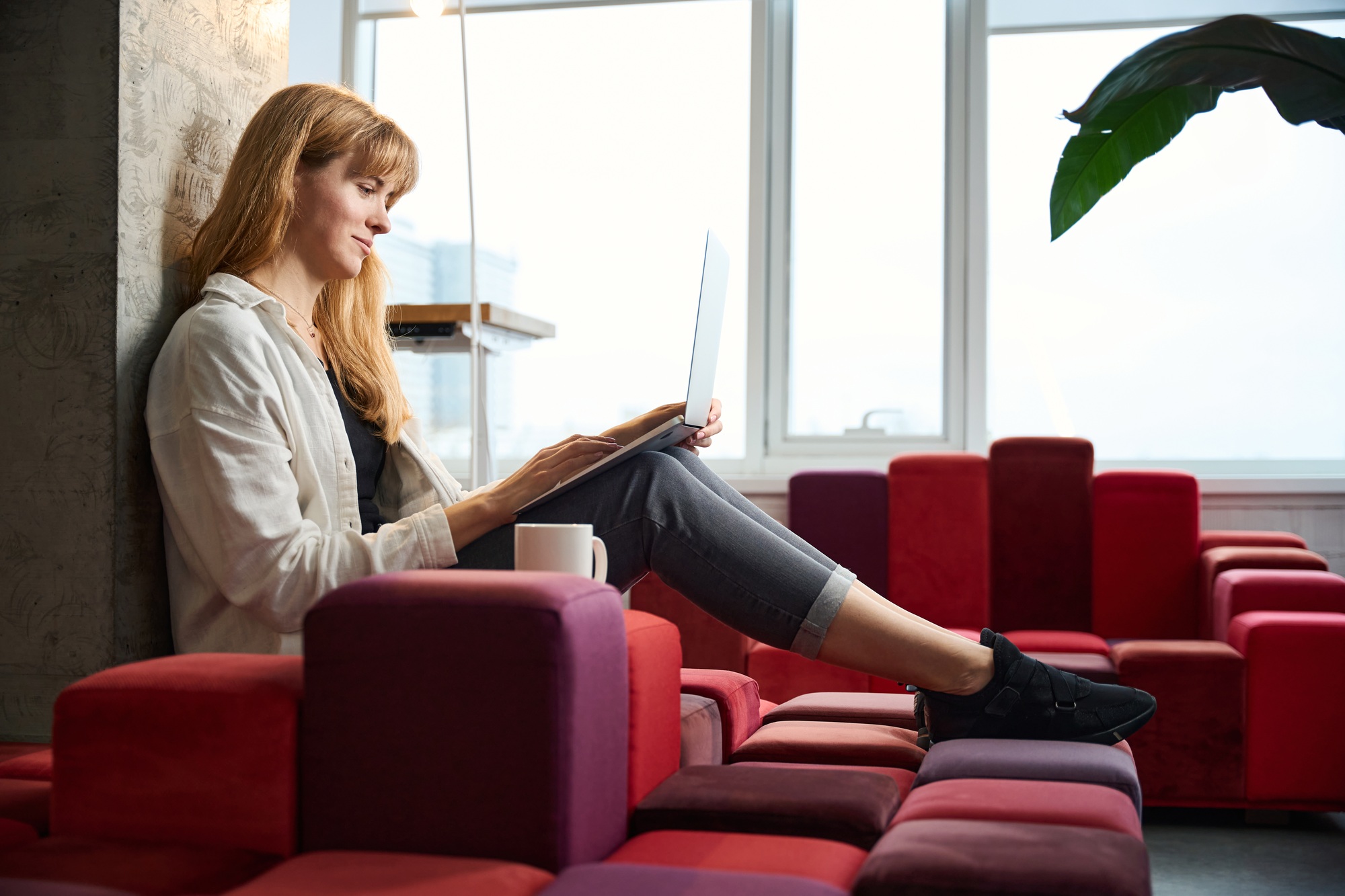 Fashion designer working with sketches on laptop