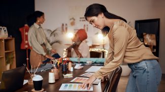 Fashion, workshop and manufacturing women at night for small business, startup production or retail