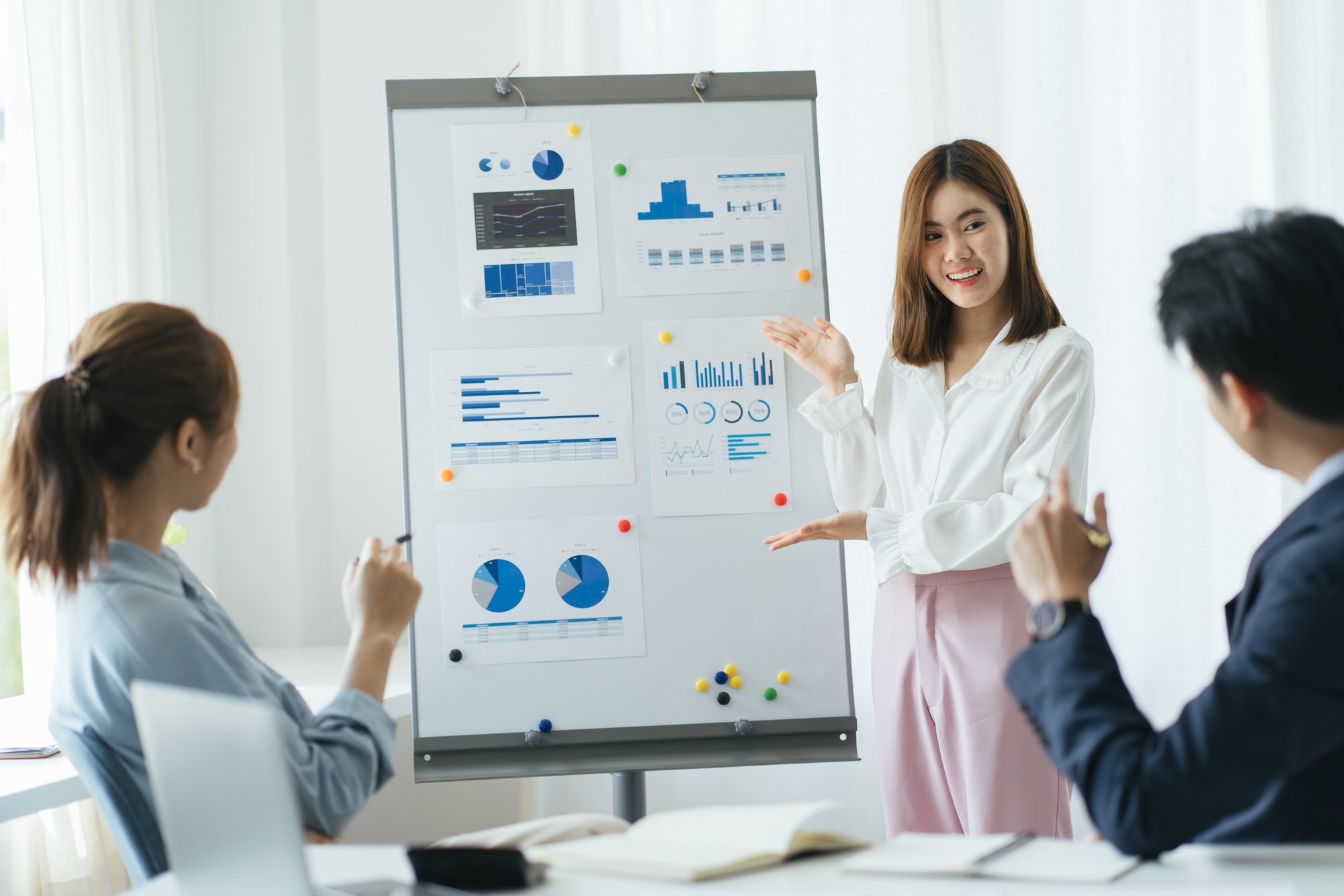 Group of mature businesspeople planning business strategy while looking at infographic on wall. Bus