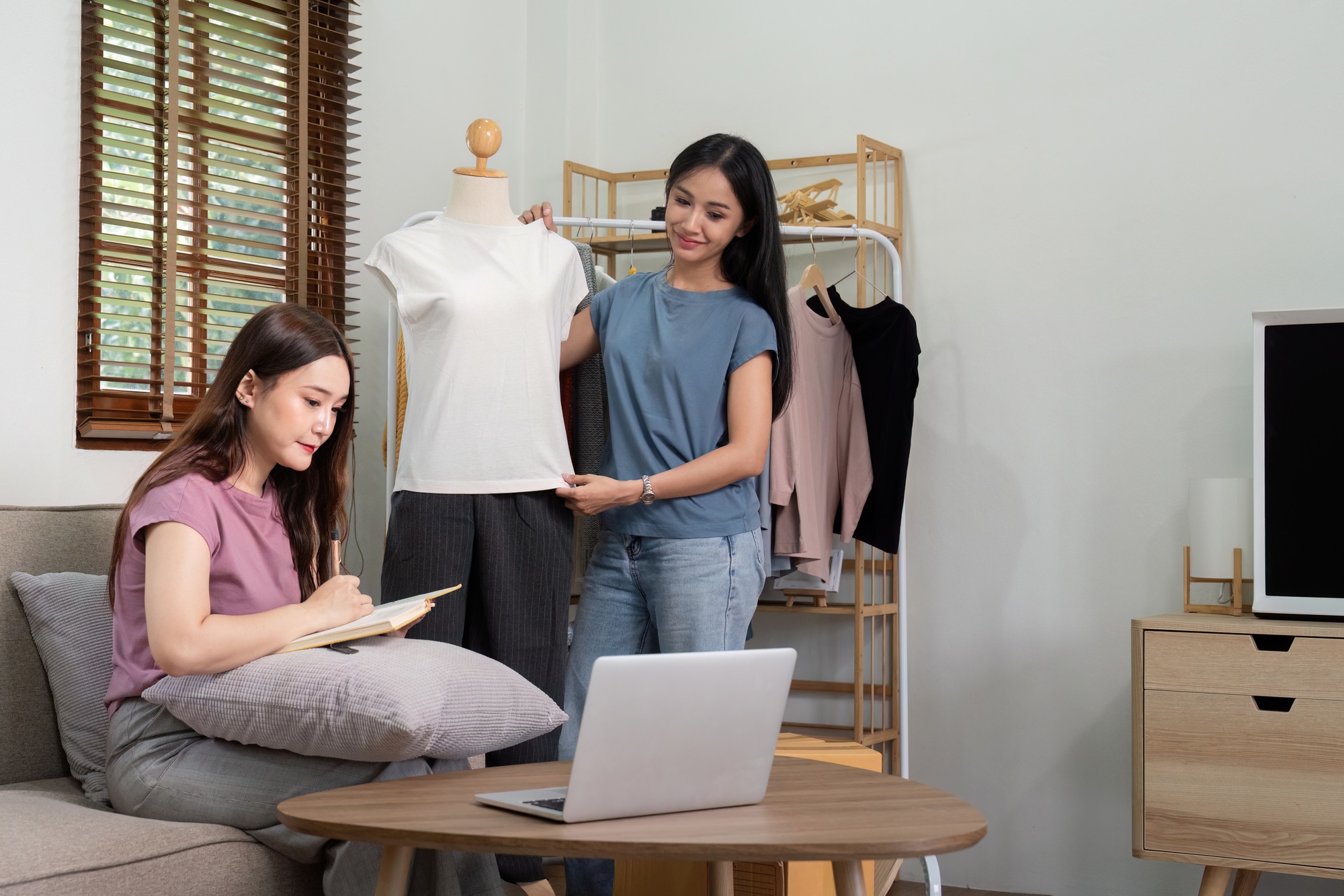Lesbian Couple Running Online Clothing Business from Home, Collaborating on Fashion Designs and