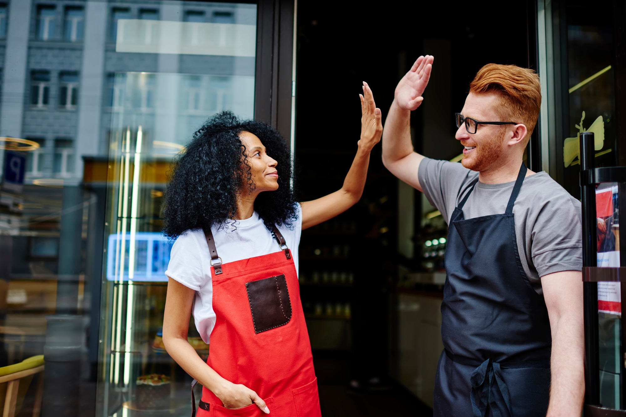 Low angle of delighted multiethnic business partners in casual clothes