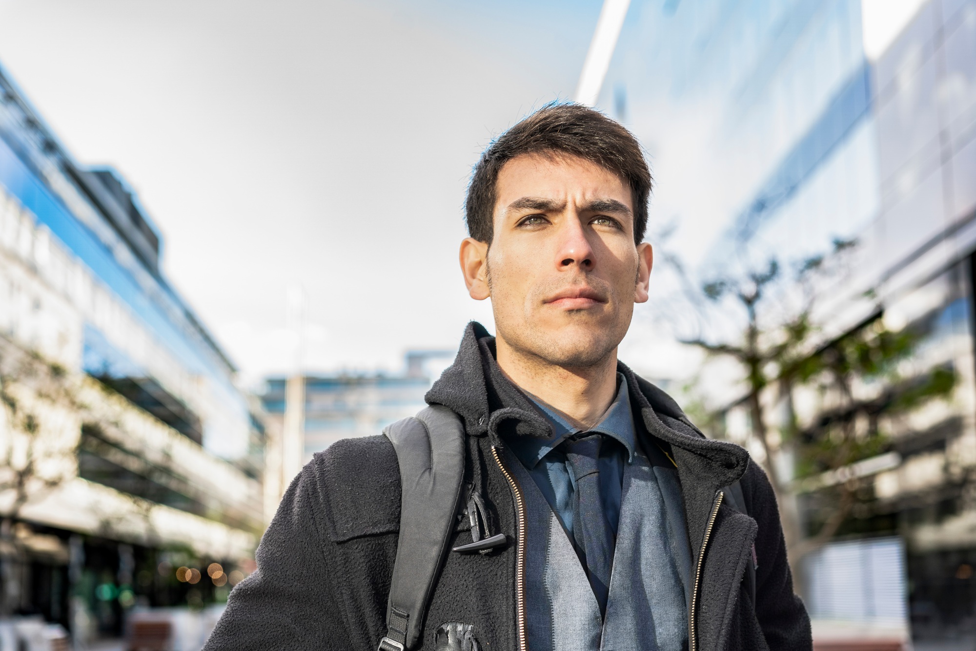 Low-angle view of an attractive businessman with his backpack on