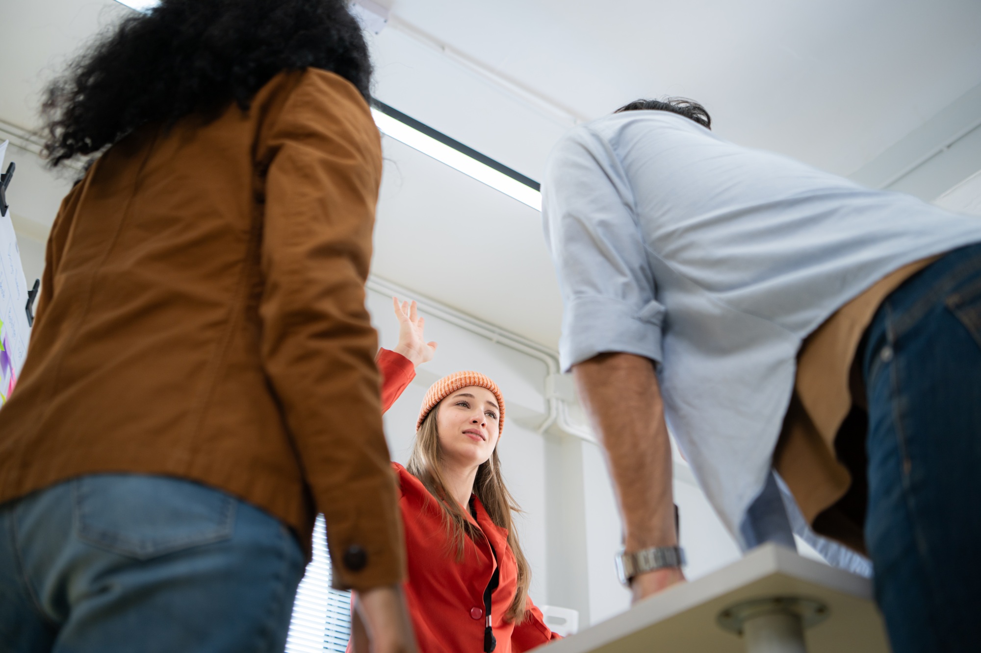 Low angle view of businesswoman giving high five to colleague in office