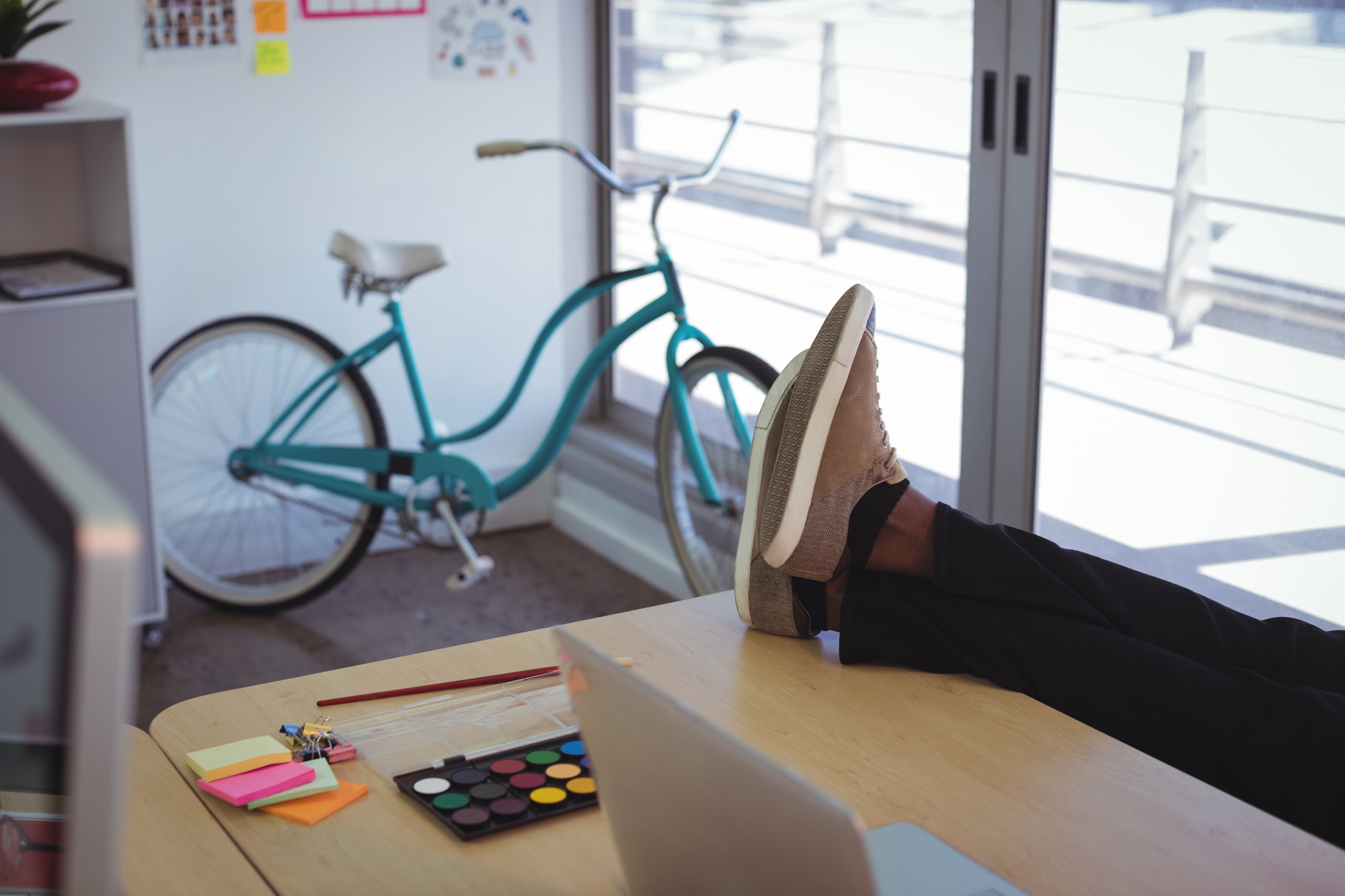Low section of businessman on desk in office