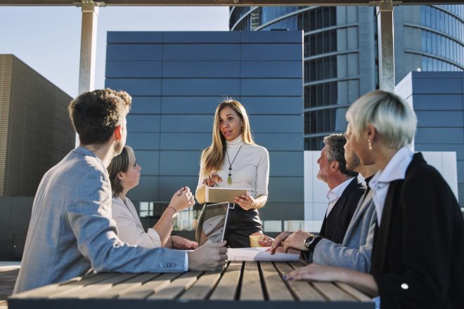 Middle age woman leading business creative team in mobile application software design project