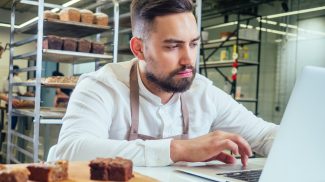 Retail trade concept , man owner of food factory using devices for online business