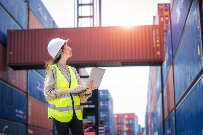 Staff worker work check stock inventory for control loading Containers box.