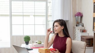 Startup small business owner working at house. Young asian woman happy with the sale of goods online