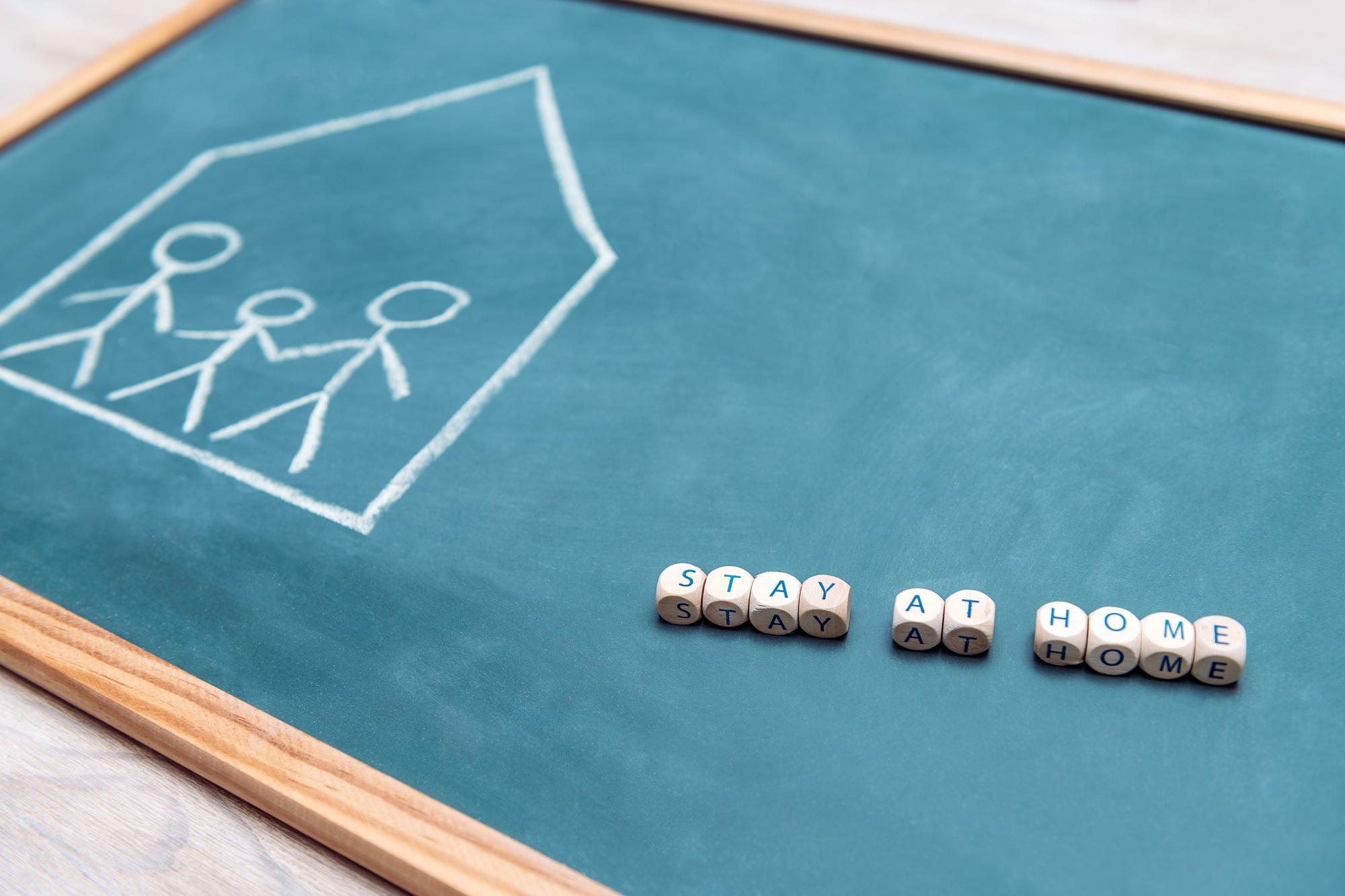 stay at home message over a blackboard
