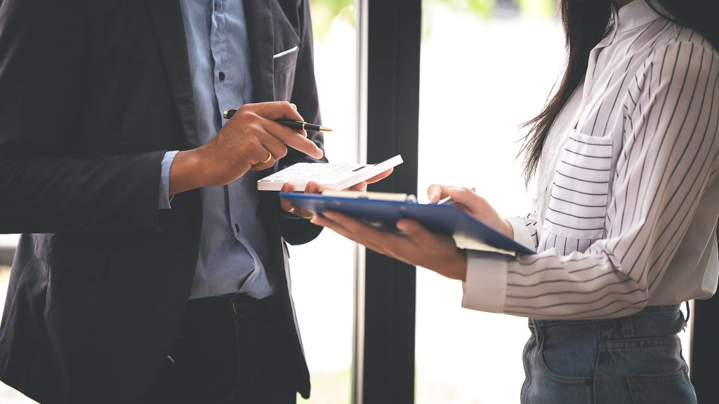 Teamwork with business analytic price charts at the conference room.