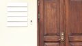 Wooden office doors with blank company signboards on the wall