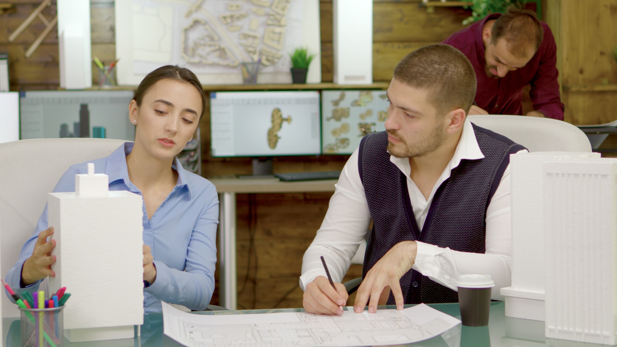 Young and talented architects changing the plans for a business buildings