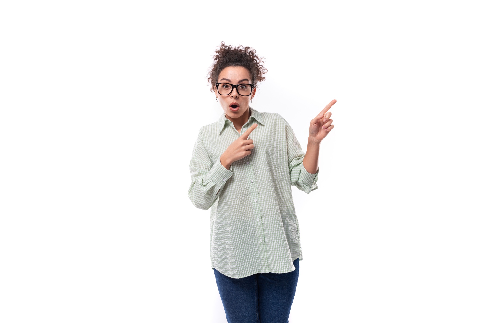young woman teacher with curly black hair shows her hand to the side